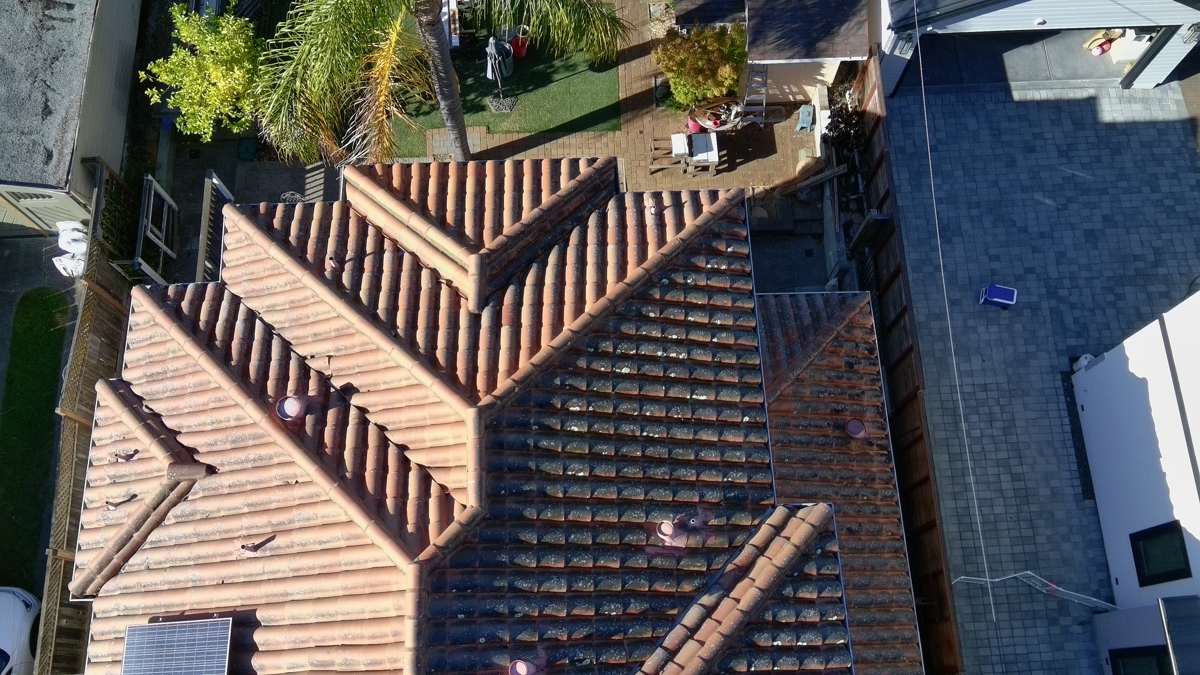 Before — Burlingame Spanish tile roof with lichen spreading across surface