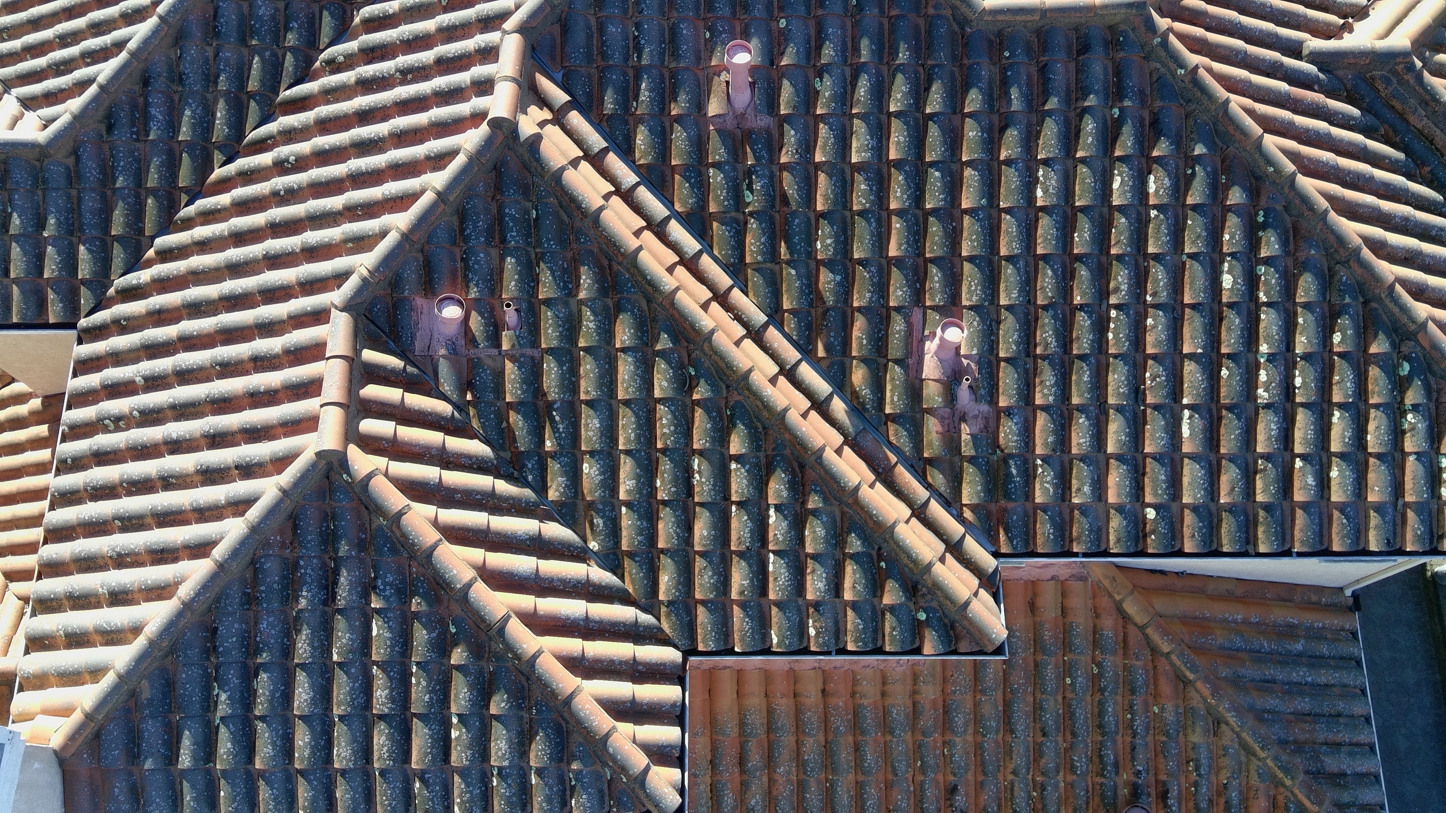 Before — Burlingame terracotta tile roof with organic buildup in tile valleys