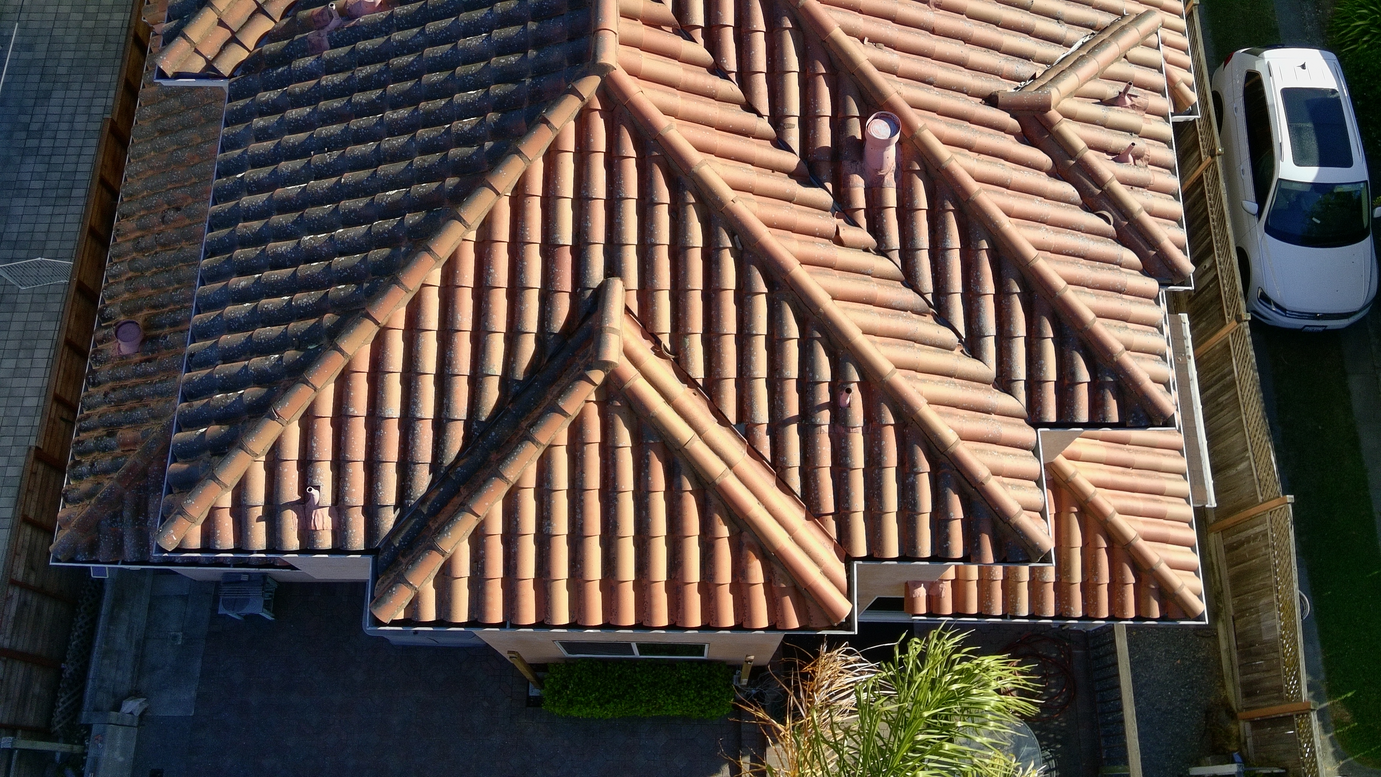 Before — Burlingame Spanish tile roof showing extent of moss and algae before soft wash