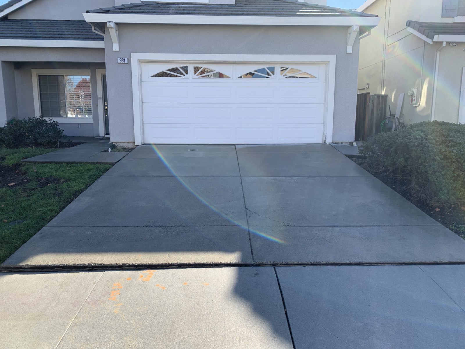 After — full Fremont driveway evenly cleaned in front of the white garage door, no wand stripes