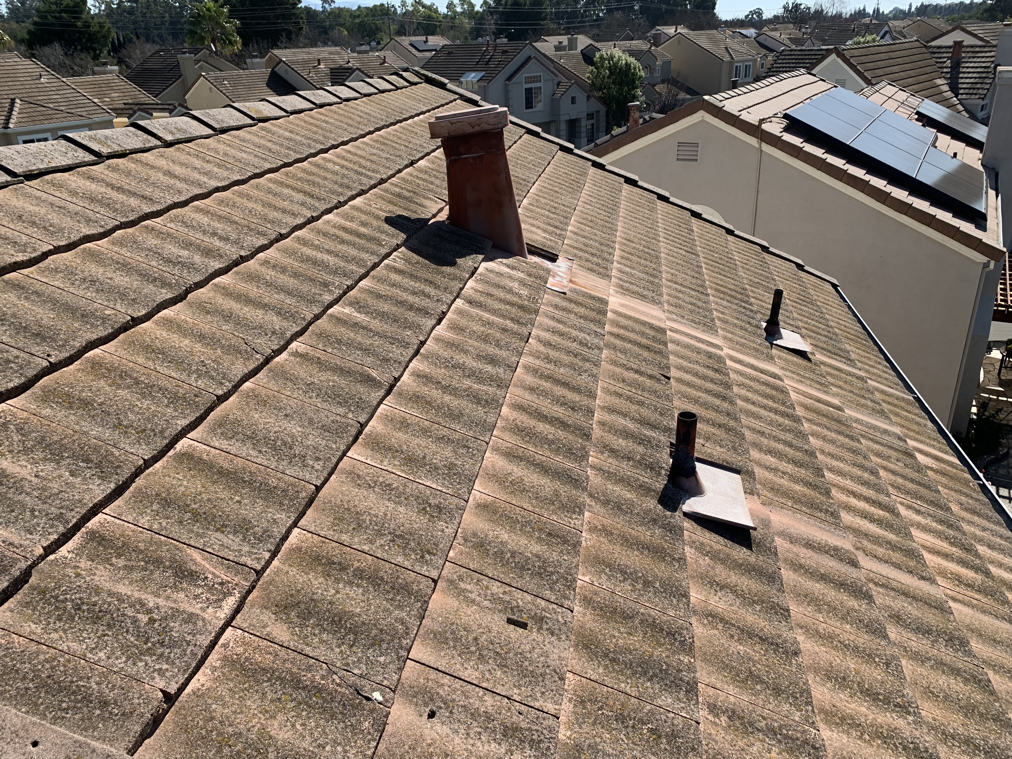 Before — Fremont flat tile roof valley with debris and growth before service