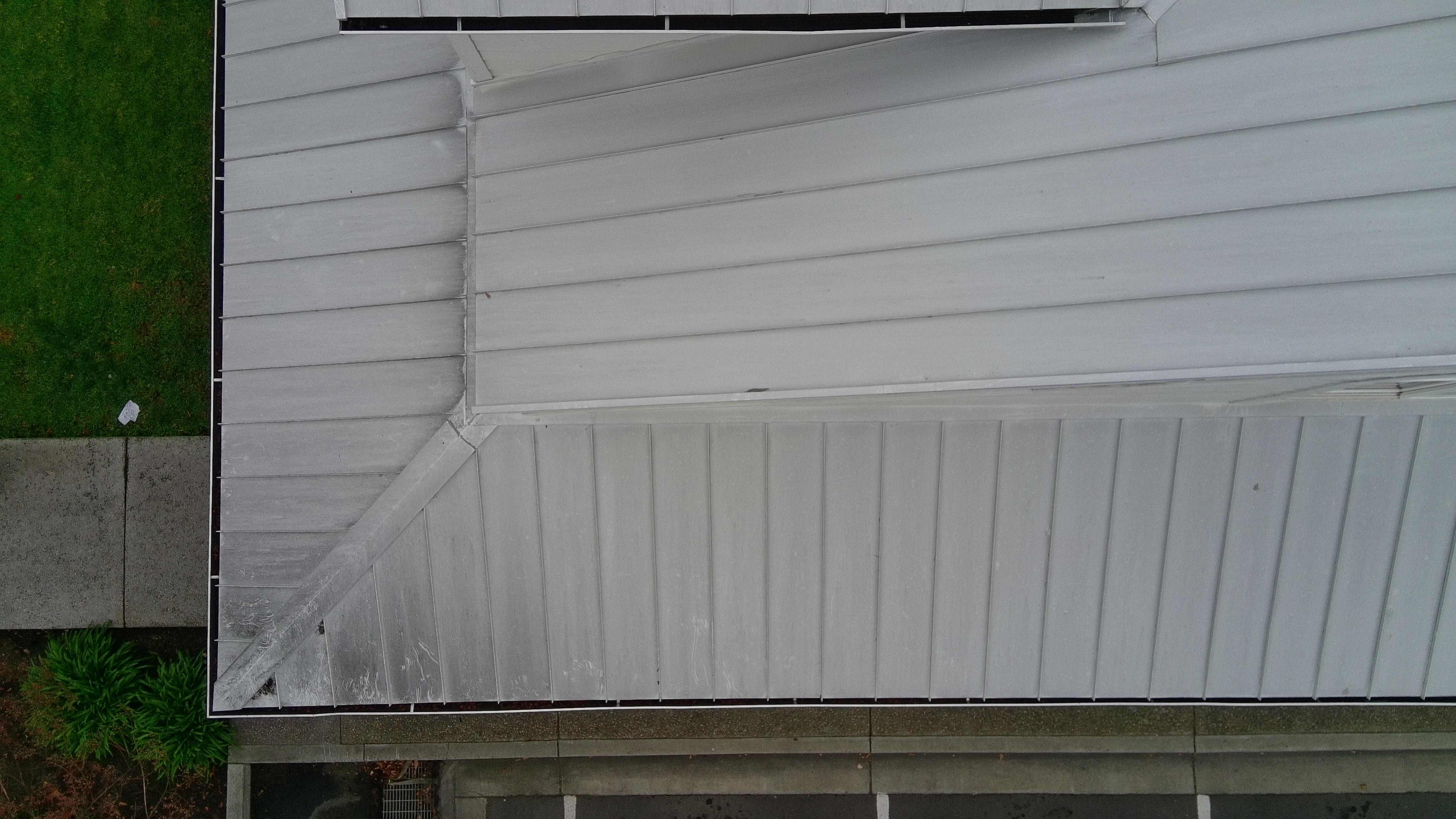 Before — Fremont standing seam metal roof oxidation streaking along seams