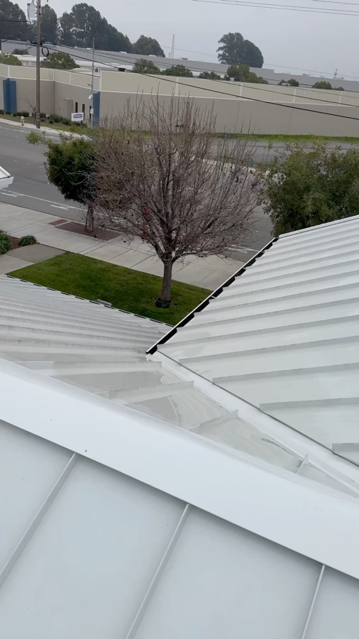 Cleaned standing seam metal roof ridge on a commercial building in Fremont, California