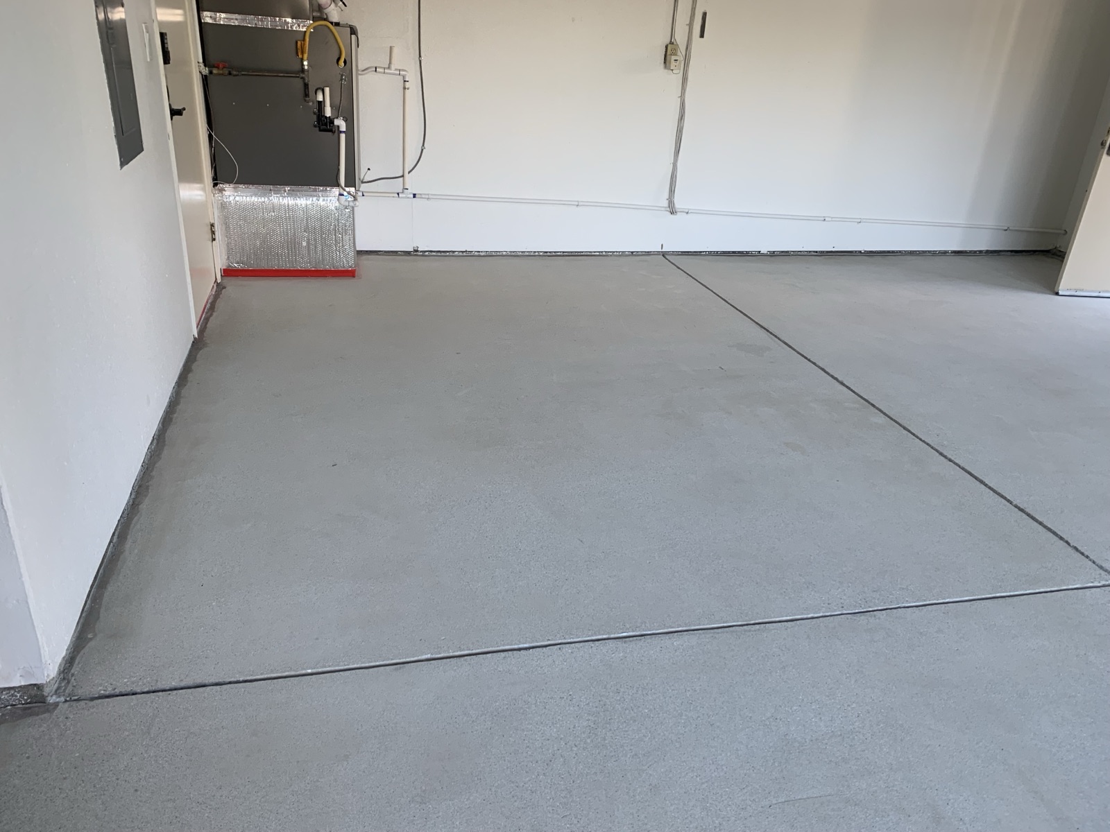 Before — Fremont garage slab diamond ground with edges cut in, ready for the epoxy base coat