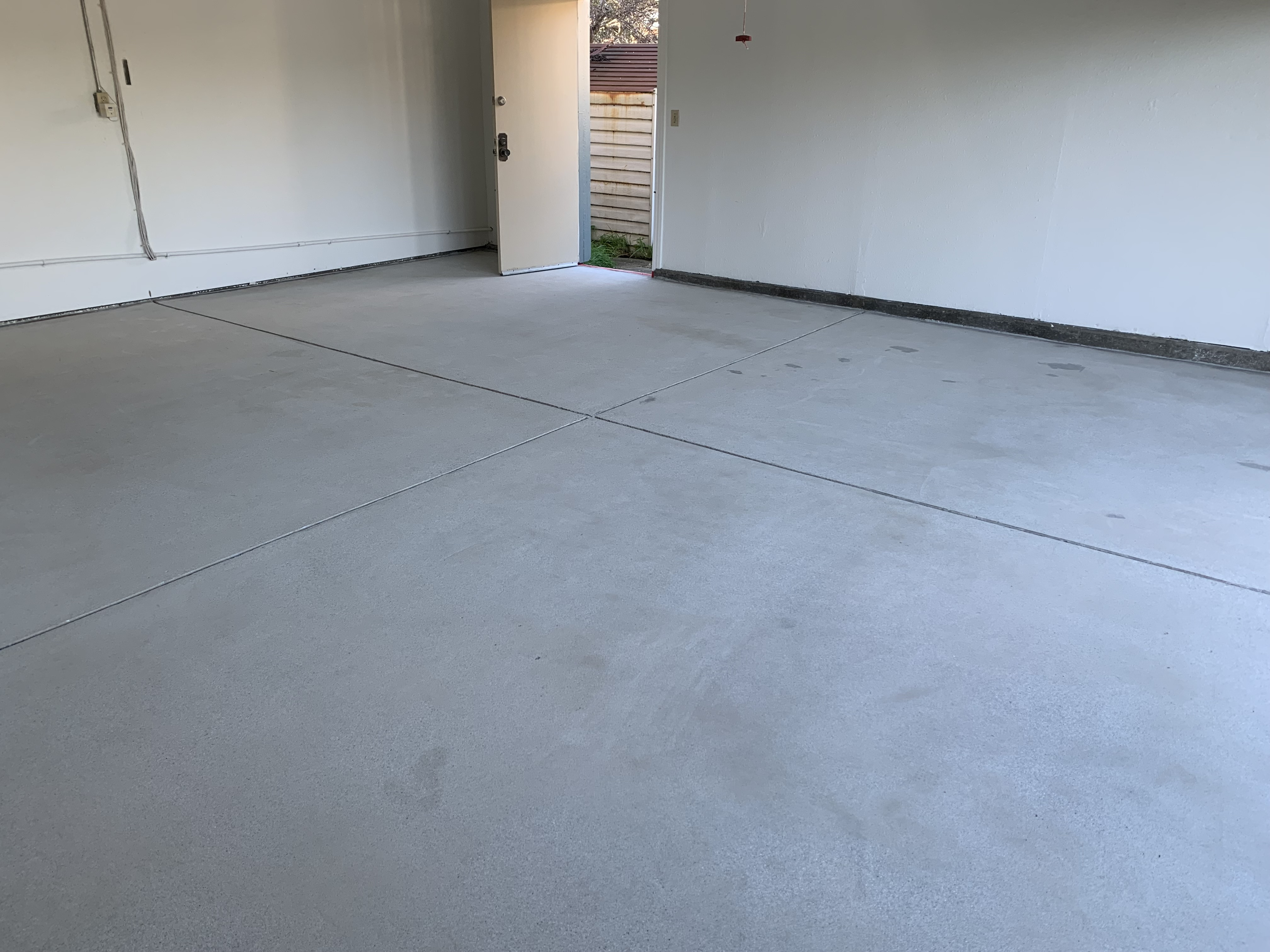 Before — Fremont concrete floor with pitting and staining before epoxy