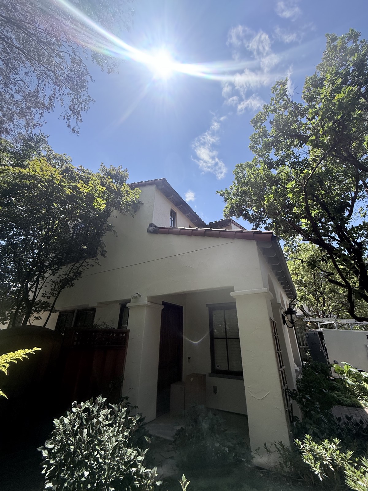 After — front of the Los Gatos stucco home clean in the sun, terracotta roofline and entry columns washed