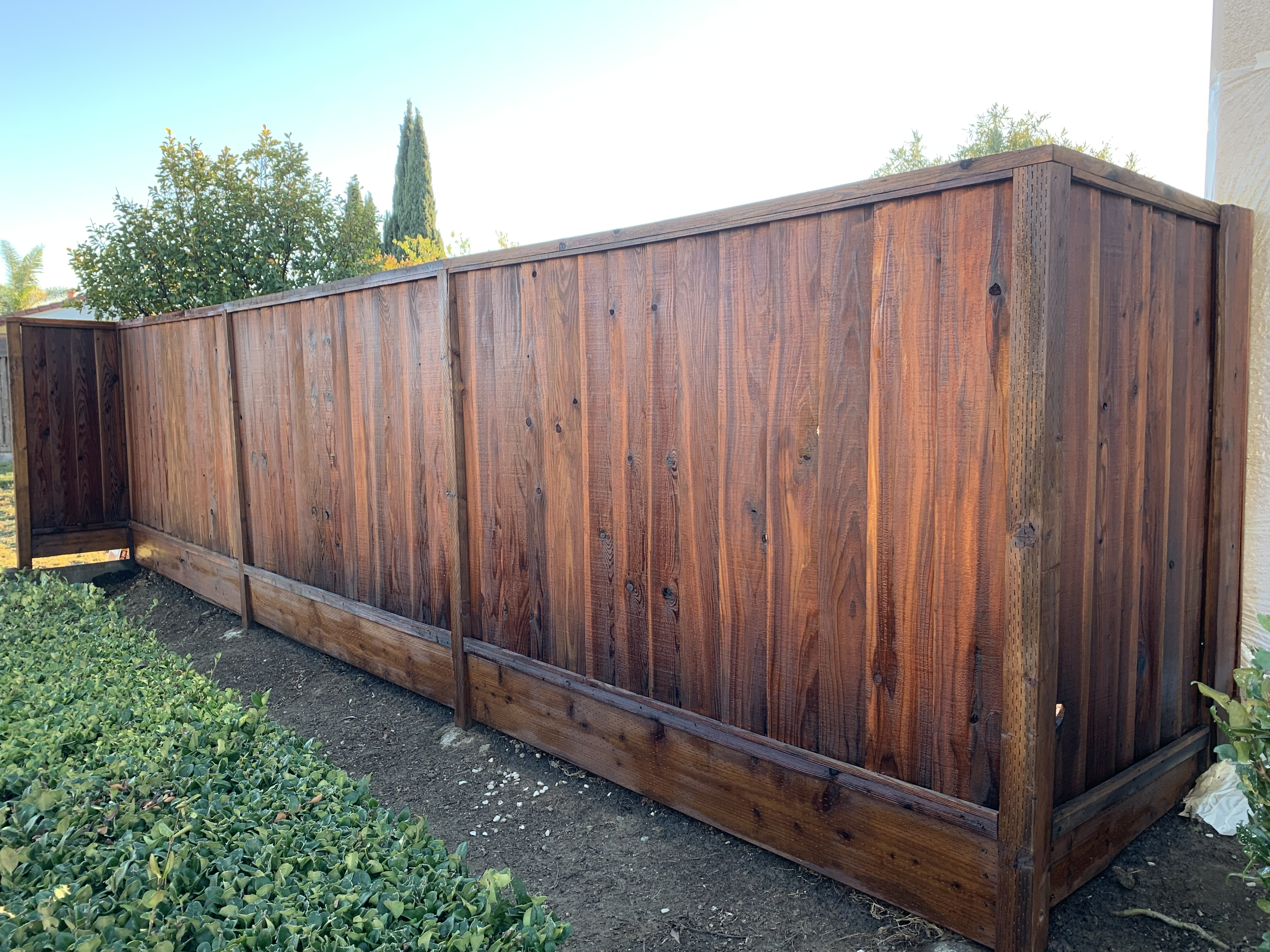 Final — Milpitas wood fence stained and finished, posts and rails complete