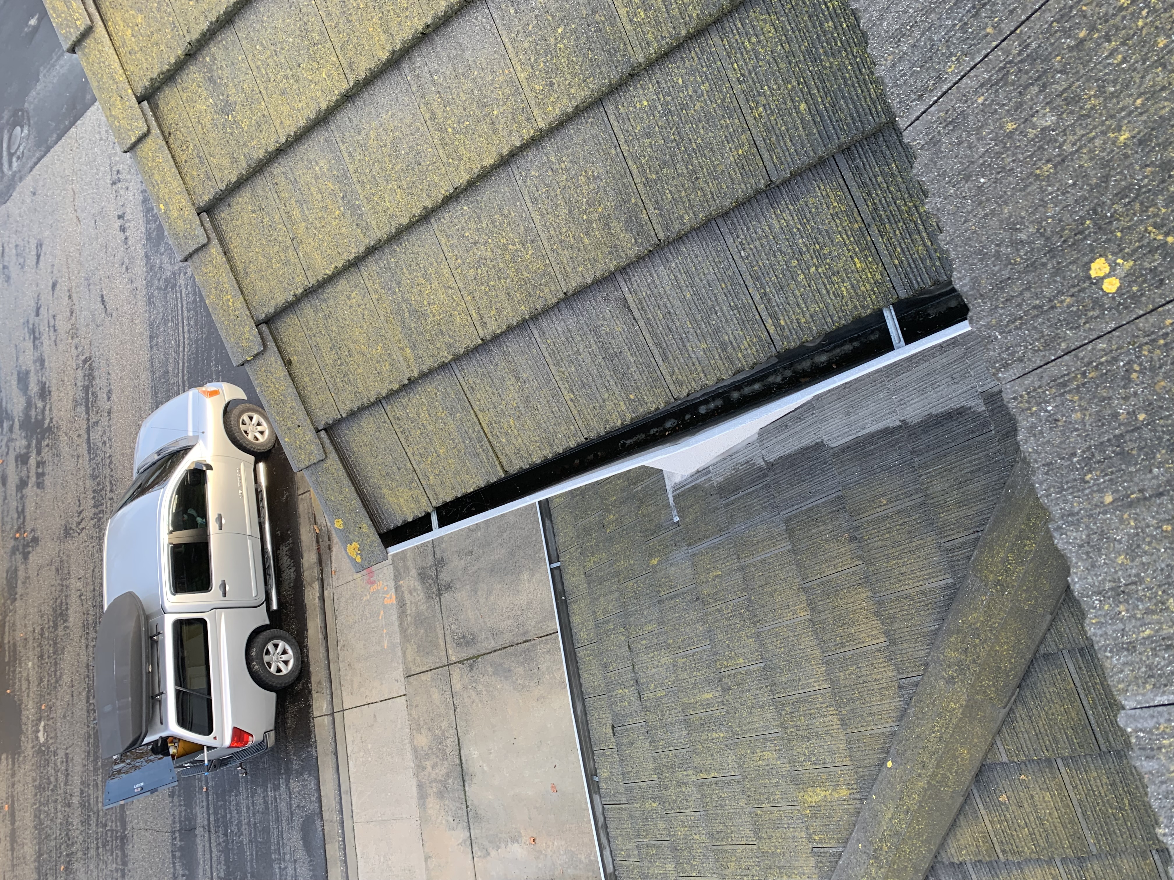 Before — Milpitas roof detail showing moss and organic buildup
