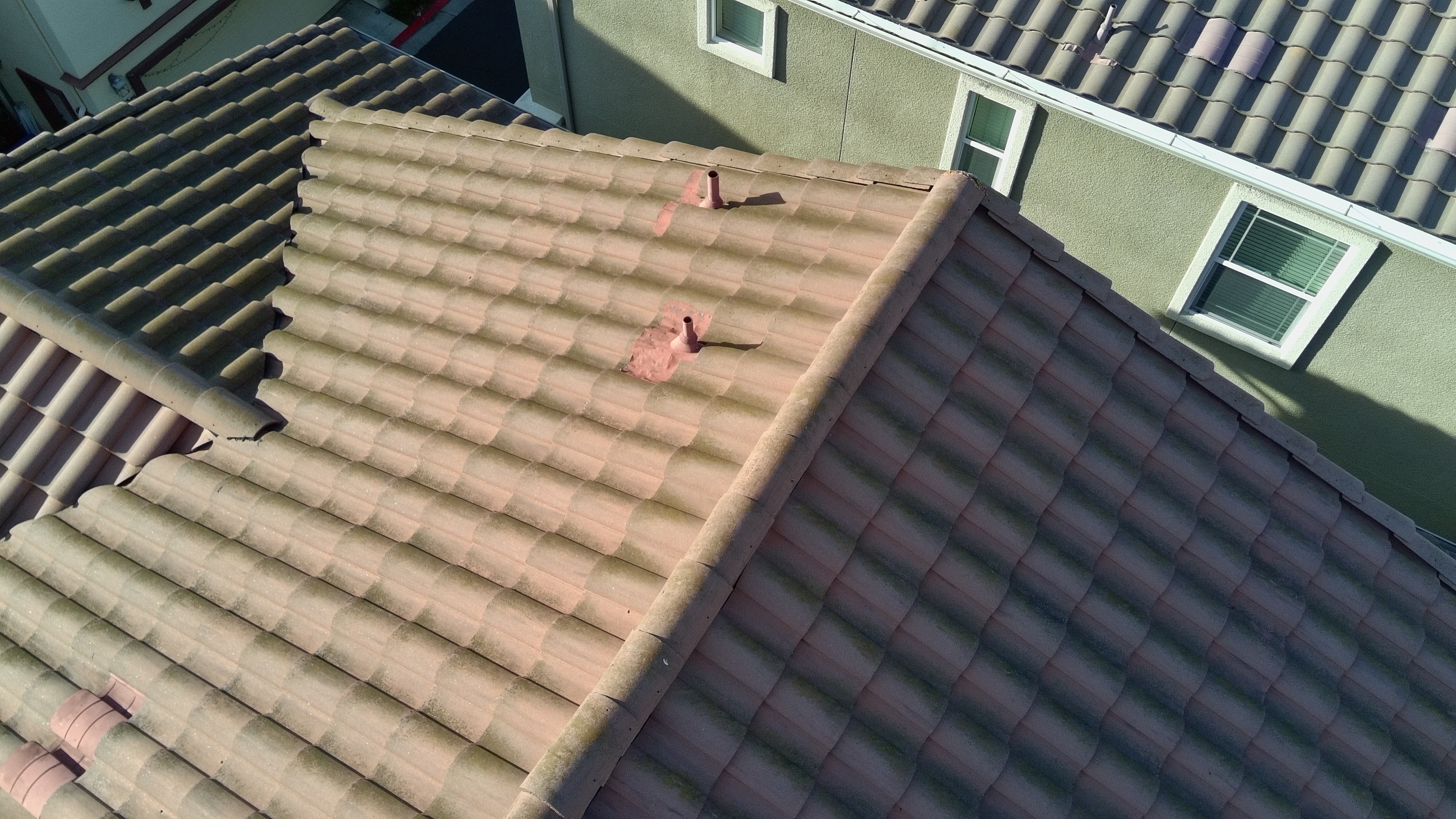 Before — North-facing Milpitas S-tile roof with heavy moss growth