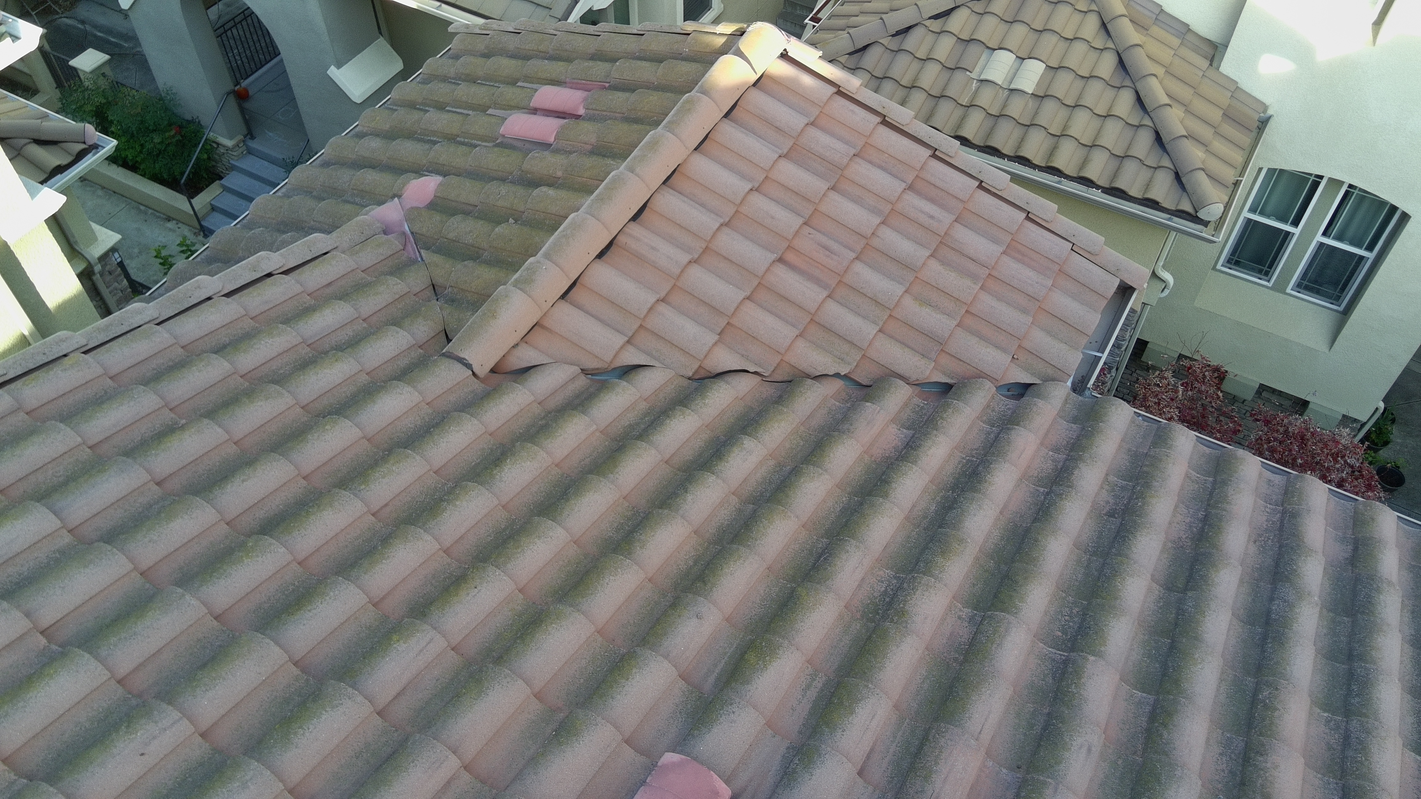 Before — Milpitas roof detail showing dark algae and moss at ridge line