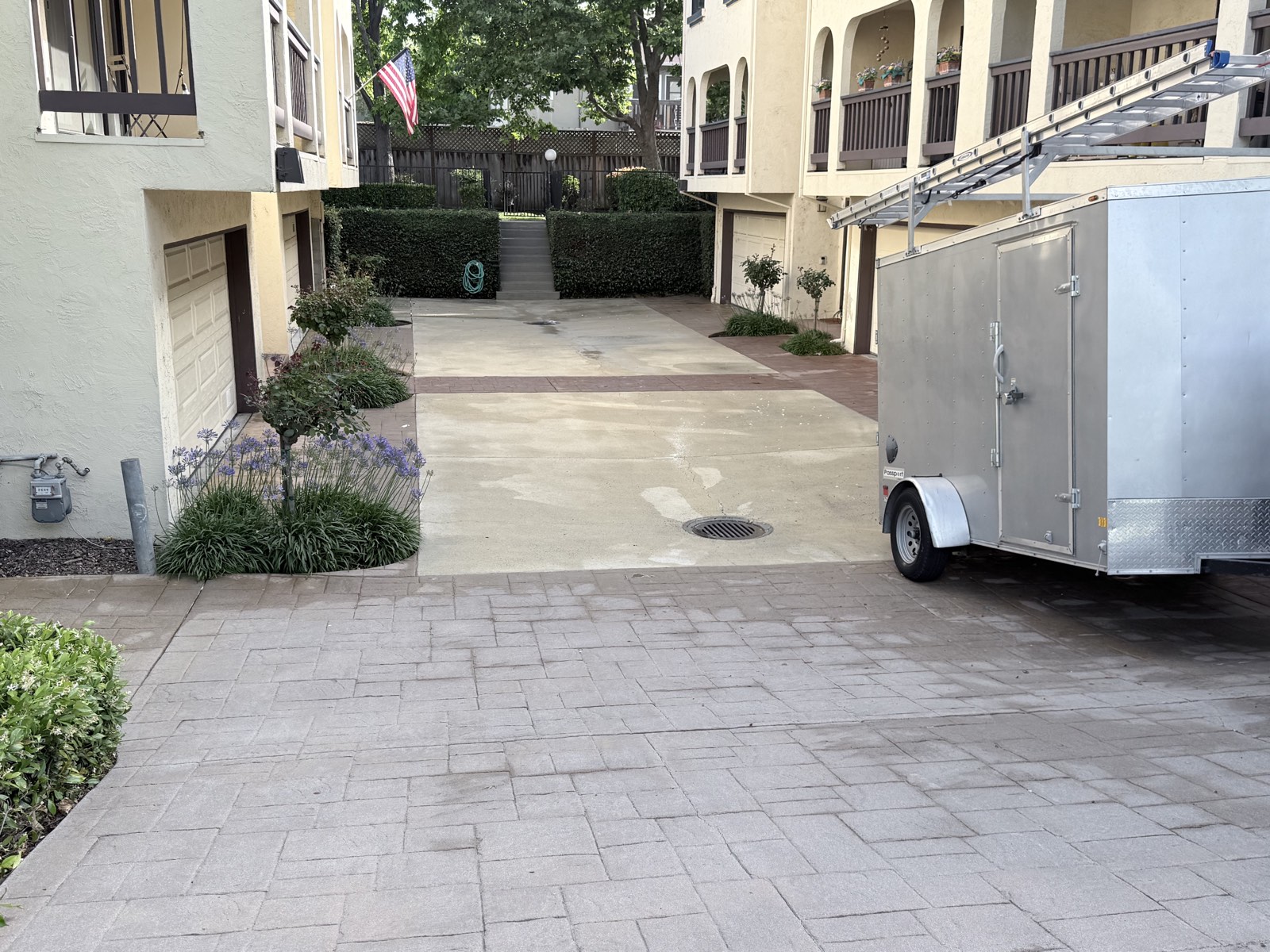 After — cleaned drive court and courtyard steps between the townhome buildings, equipment trailer at the garages