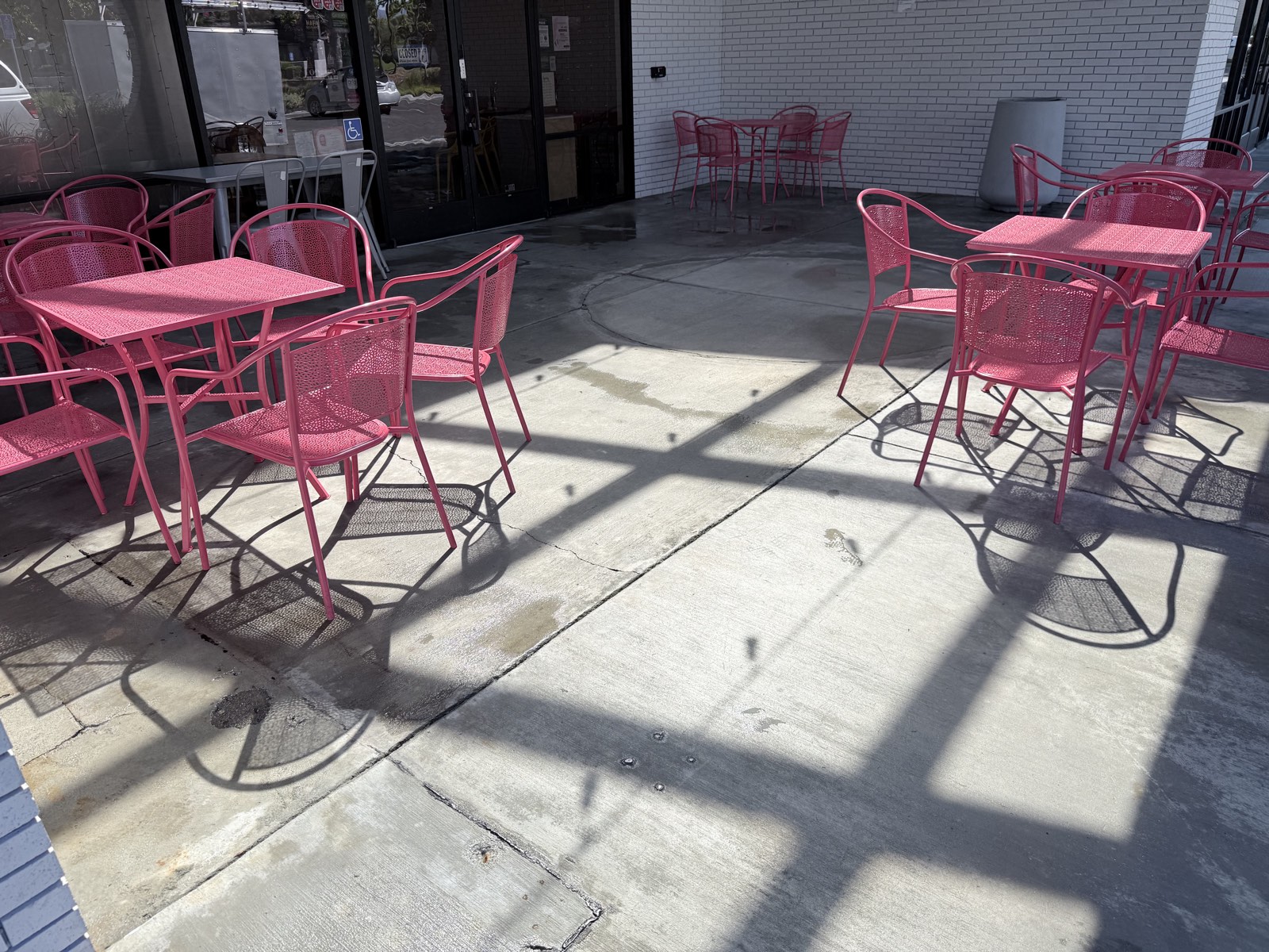 After — patio seating areas back on bright, even concrete outside the San Jose storefront