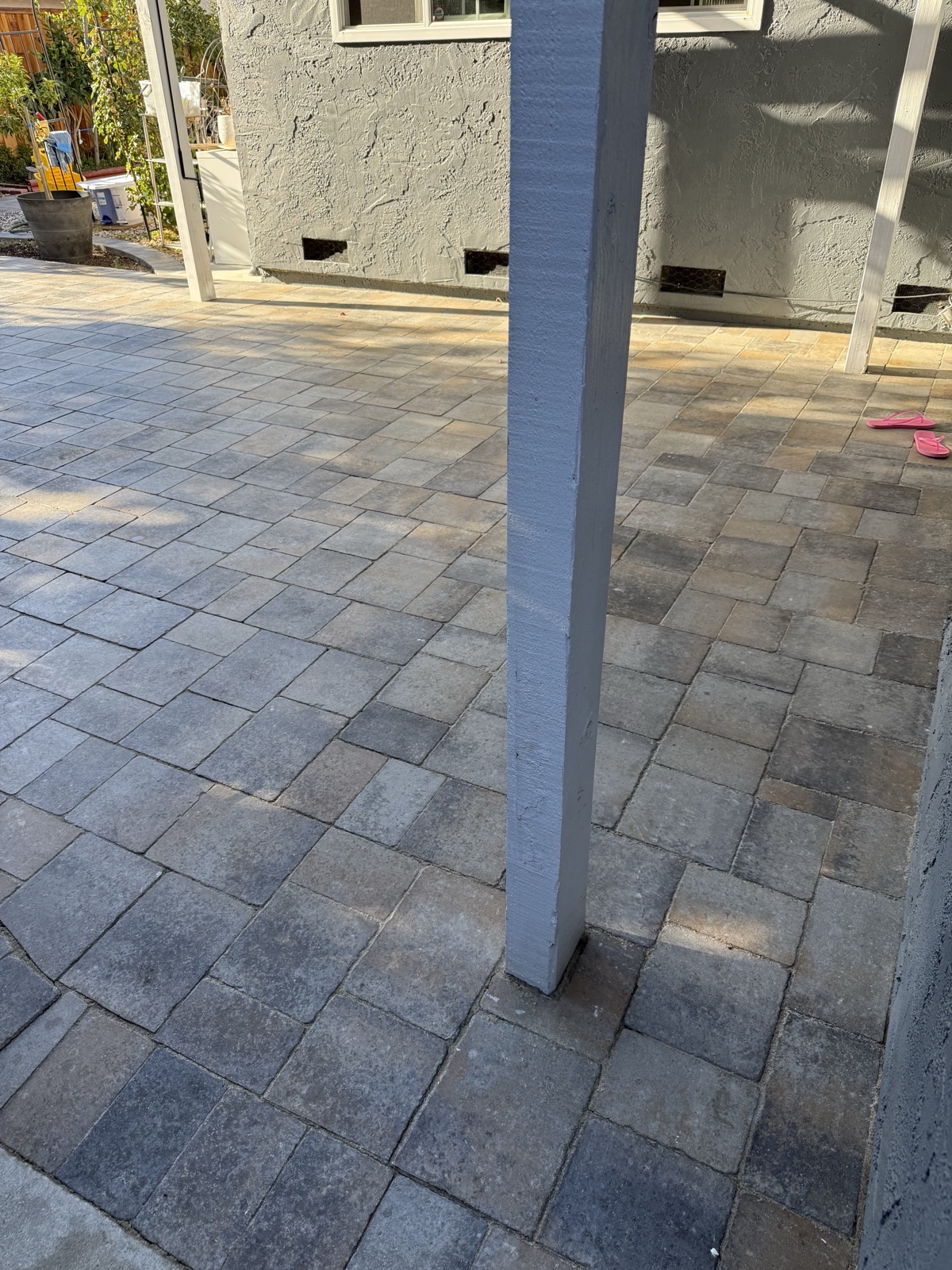 After — cleaned San Jose paver patio around the pergola post, gray and tan paver tones showing evenly again
