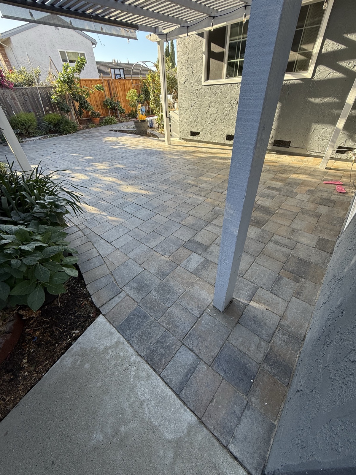 After — San Jose backyard paver patio and border courses cleaned, staining removed and blended color restored