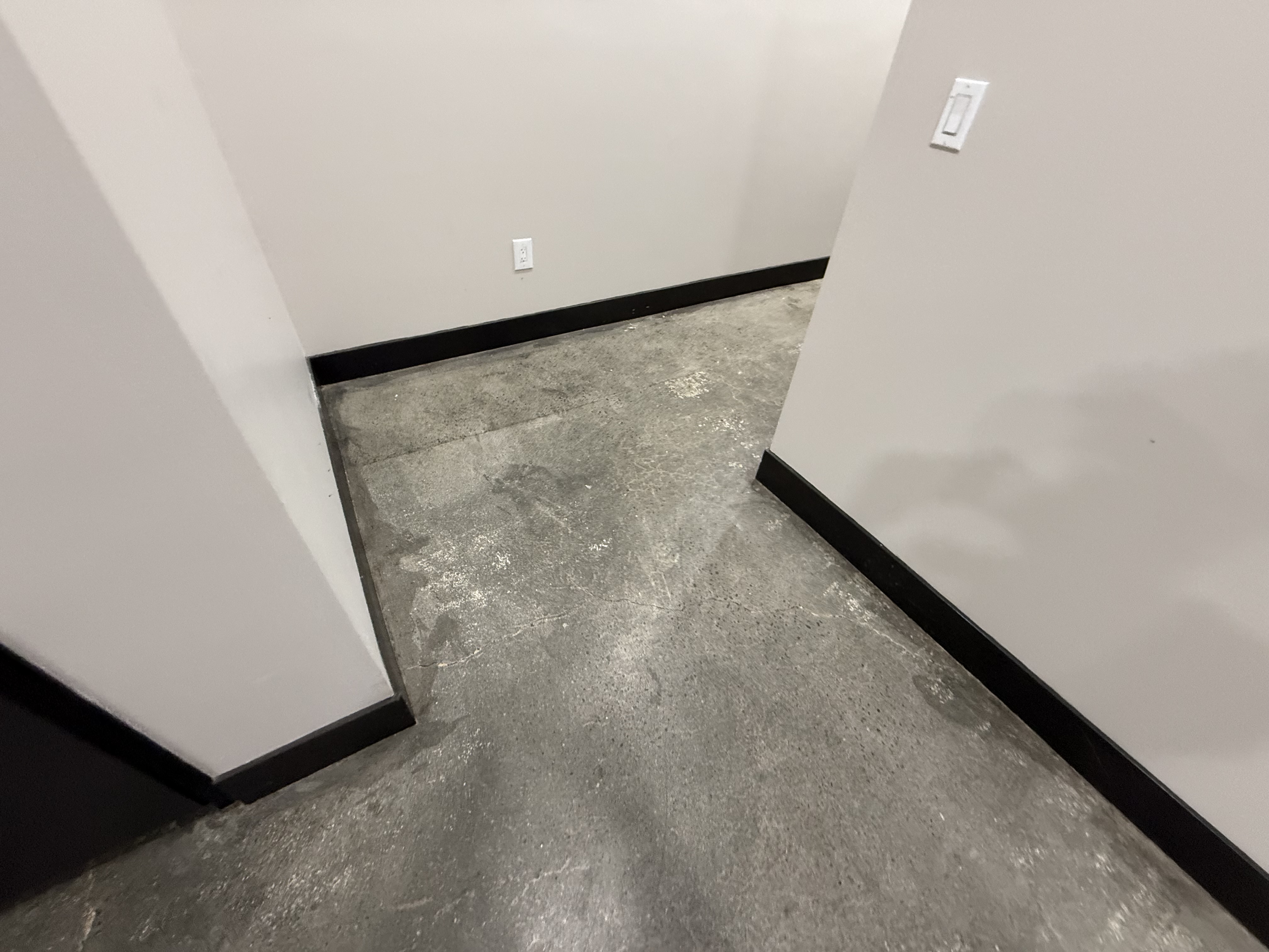 Before — San Jose floor with oil stains and pitting before epoxy