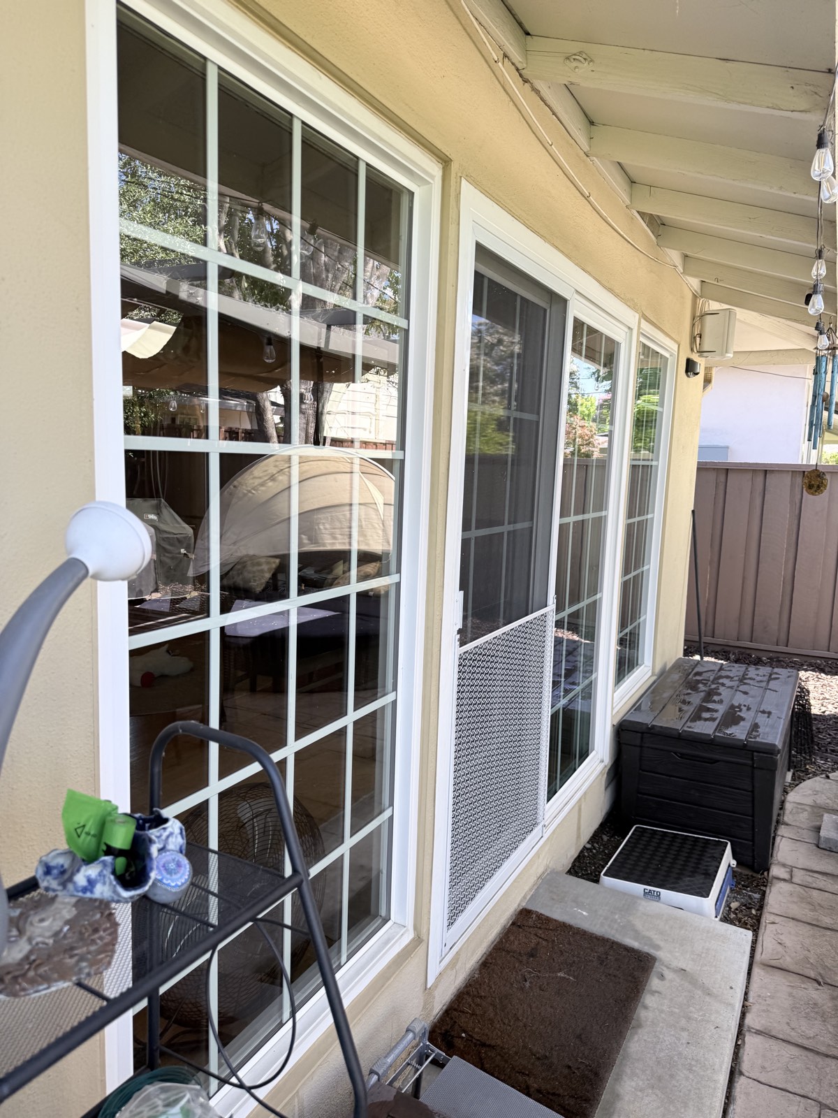 After — patio windows and sliding door glass cleaned clear, backyard visible through the panes