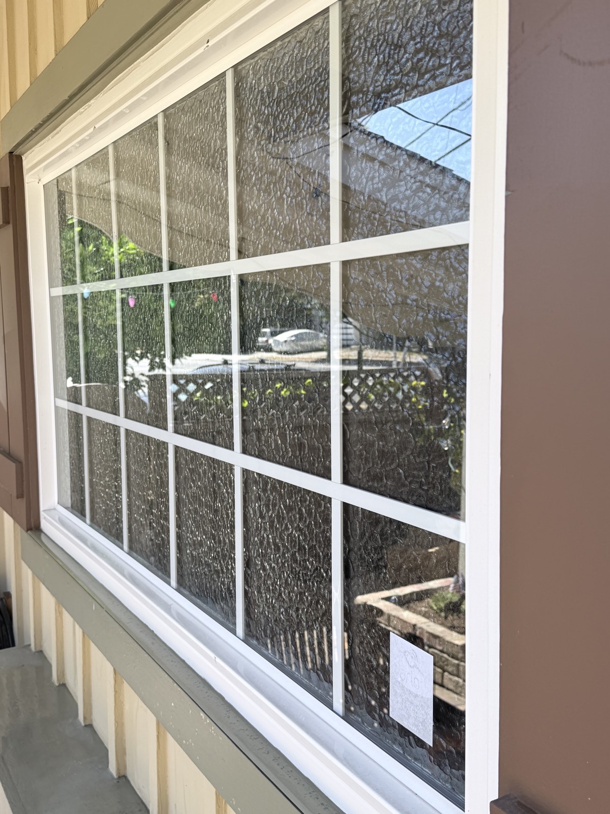 After — wide multi-pane window with textured privacy glass washed clean, white grids bright