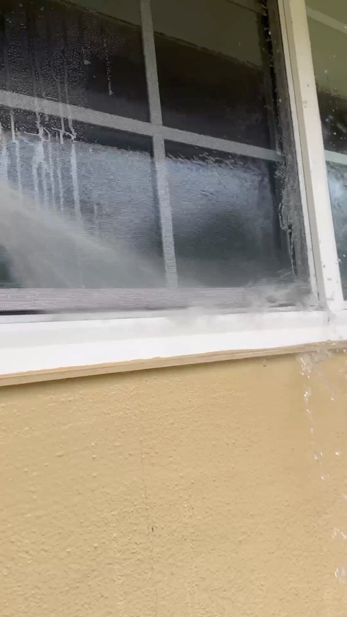 Rinsing exterior window glass with a water-fed pole in San Jose, California